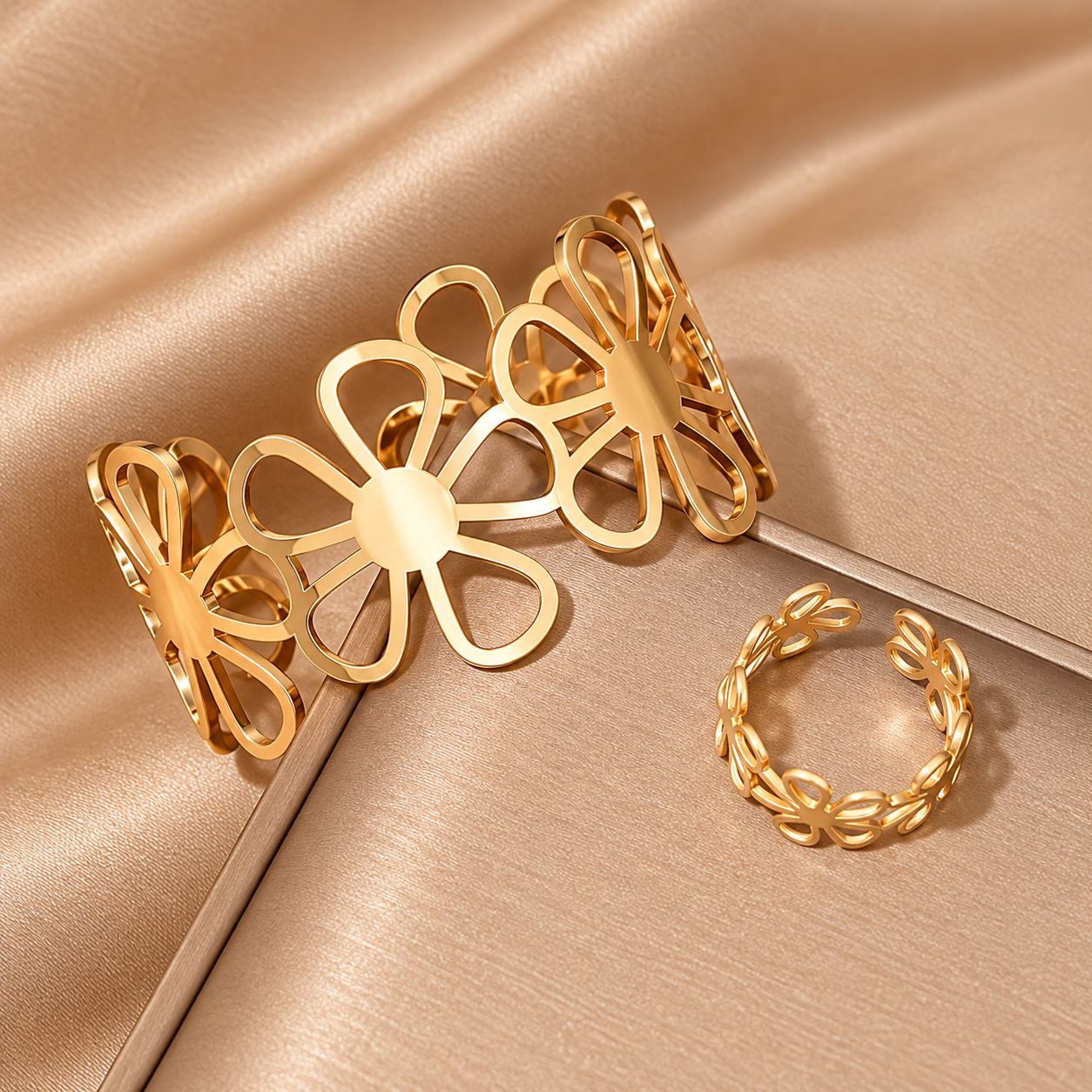 Conjunto de pulsera y anillo dorados con diseño floral